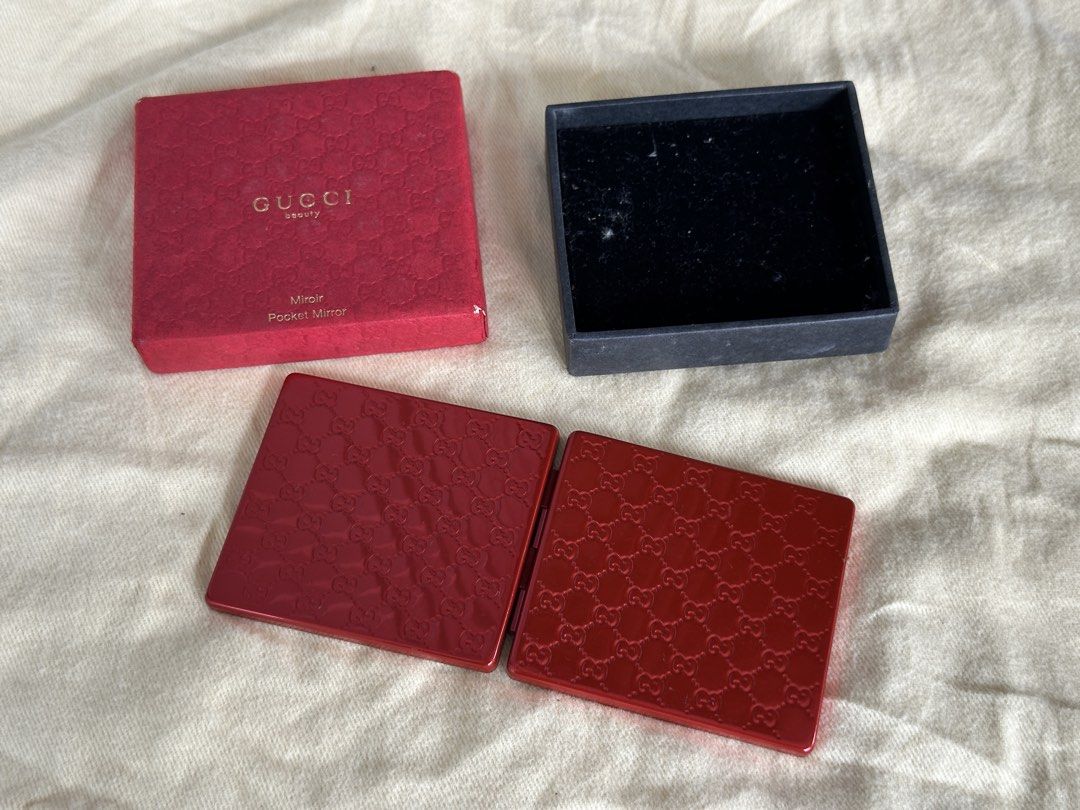 Gucci Beauty Pocket Mirror (Category: Face Care) located in Bustos. Submitted by theprelovedshopbulacan (Listing ID 1433218221, Image 2). Description: - Authentic Gucci Beauty pocket mirror - Red color - Square shape - Embossed Gucci logo - Comes with original red box - Box features Gucci Beauty logo - Opens to reveal two mirrors.