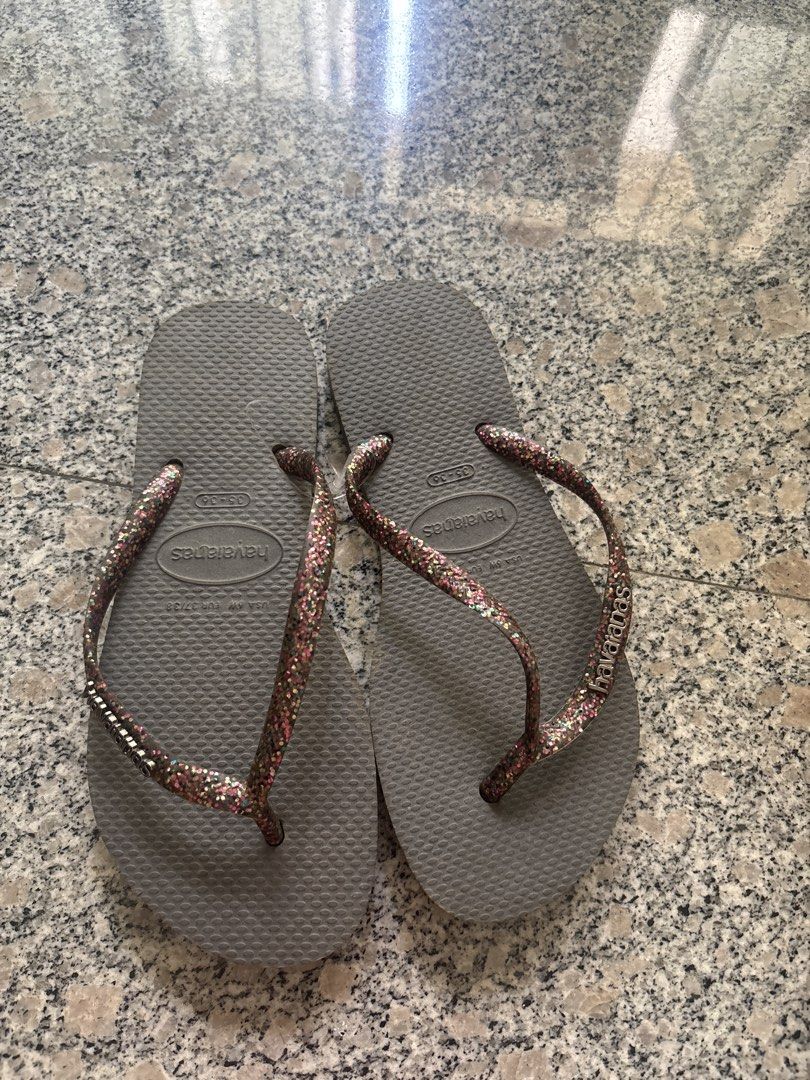 Havaianas Grey Flip Flops with Glitter Straps (Category: Flipflops and Slides) located in Singapore. Submitted by wenng123 (Listing ID 1433248458, Image 1). Description: - Stylish grey Havaianas flip flops - Features glitter straps - Comfortable and durable design - Ideal for casual wear and the beach.