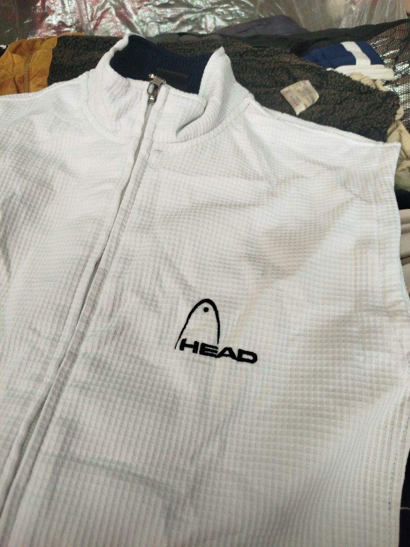 Head Sleeveless Vest - White (Category: Vests) located in Quezon City. Submitted by madrilejod31663 (Listing ID 1433244187, Image 2). Description: - Head sleeveless vest - White with navy blue accents - Size: Medium - Full-length zipper - Stand-up collar - Textured fabric - Head logo on chest.