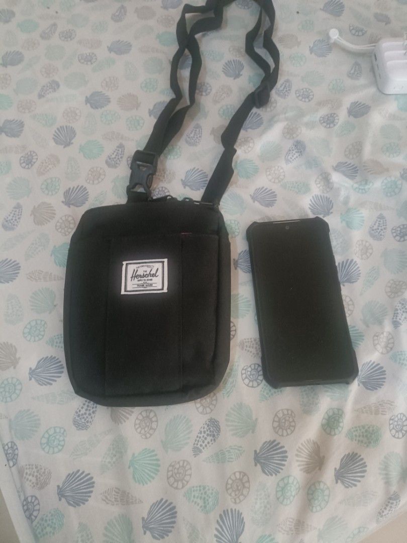 Herschel Supply Co. Crossbody Bag (Category: Cross-body Bags) located in Cebu City. Submitted by dediosmark83726 (Listing ID 1433268300, Image 1). Description: - Black Herschel crossbody bag - Main compartment with red and white striped lining - Front pocket - Adjustable strap - Zipper closure - Herschel Supply Co. label - Fits a phone.