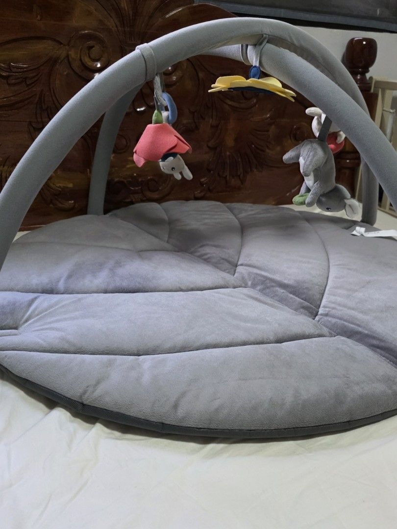 IKEA GULLIGAST Play Mat (Category: Infant Playtime) located in Cavite. Submitted by gpscloset (Listing ID 1433315756, Image 2). Description: - IKEA GULLIGAST play mat with hanging toys. - Soft, gray, round mat. - Features an arch for hanging toys. - Designed for babies and young children. - Leaf-like shape..