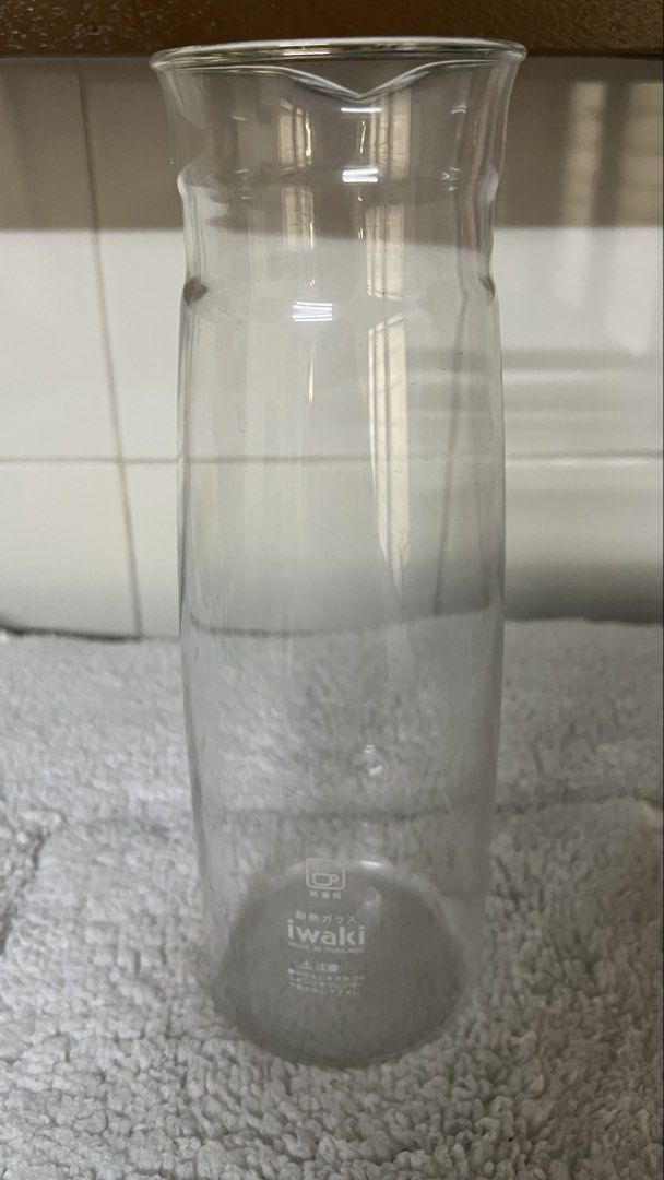 Iwaki Glass Pitcher (Category: Pitchers & Dispensers) located in Santa Ana. Submitted by hamburjei_thrifts (Listing ID 1433291141, Image 2). Description: - Iwaki clear glass pitcher - Features a convenient spout - Cylindrical body with flared top - Made of clear glass - Iwaki logo visible - Ideal for serving beverages.