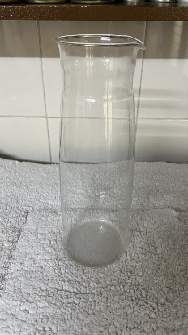 Iwaki Glass Pitcher (Category: Pitchers & Dispensers) located in Santa Ana. Submitted by hamburjei_thrifts (Listing ID 1433291141, Image 1). Description: - Iwaki clear glass pitcher - Features a convenient spout - Cylindrical body with flared top - Made of clear glass - Iwaki logo visible - Ideal for serving beverages.