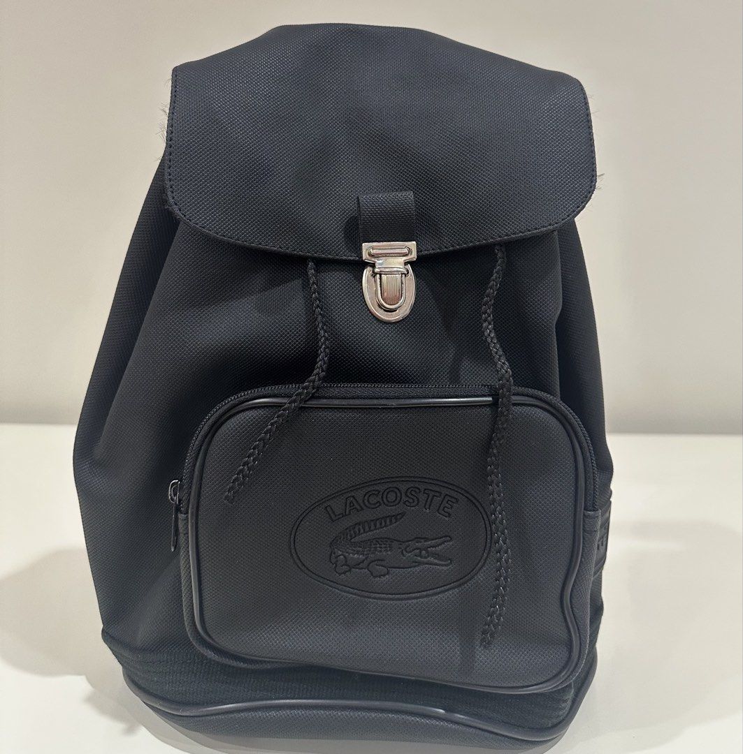 Lacoste Black Backpack (Category: Backpacks) located in Manila. Submitted by caseller26 (Listing ID 1433325796, Image 1). Description: - Black Lacoste backpack - Front pocket with Lacoste logo - Drawstring closure - Flap with metal clasp - Made of durable fabric - Classic design - Ideal for everyday use.