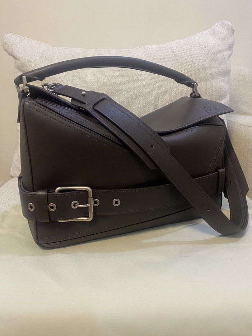 Loewe Biker Large (Category: Luxury Bags & Wallets) located in Silang. Submitted by girlyouneedthis (Listing ID 1426349750, Image 2). Description: Loewe Puzzle Biker in Large size in this beautiful dark brown color. Coded, genuine leather, comes with box and dustbag, clear stampings. Can be shoulder nag, top handle bag and crossbody bag, A very versatile bag! Height approximately 22cm-8.5” Width approximately 34cm-13.5” No returns, No exchange, N