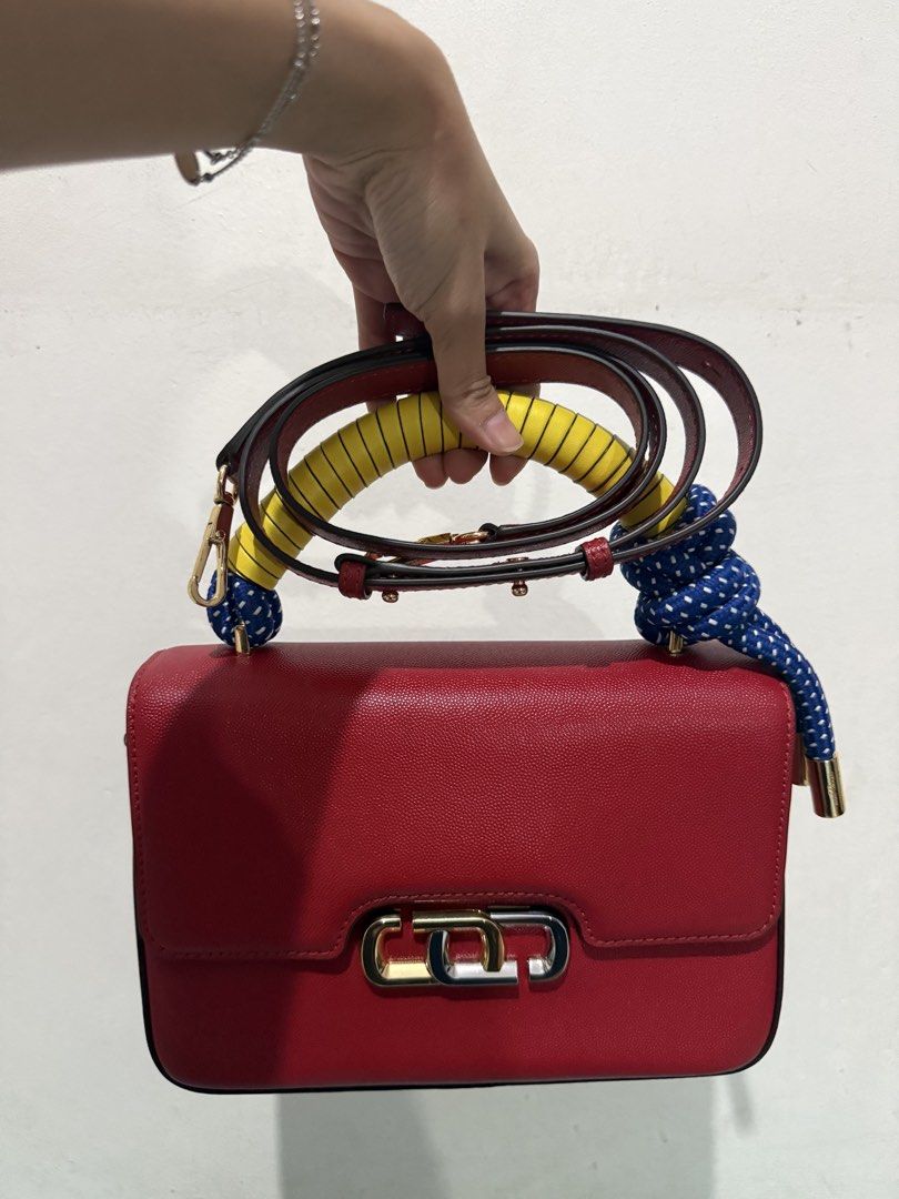 Marc Jacobs (Category: Luxury Bags & Wallets) located in Marikina City. Submitted by ayessadimagiba_753 (Listing ID 1433320177, Image 2). Description: - Marc Jacobs Red handbag - Unique rope handle with yellow and blue accents - Rectangular shape - Flap closure - Gold-tone clasp - Detachable shoulder strap.
