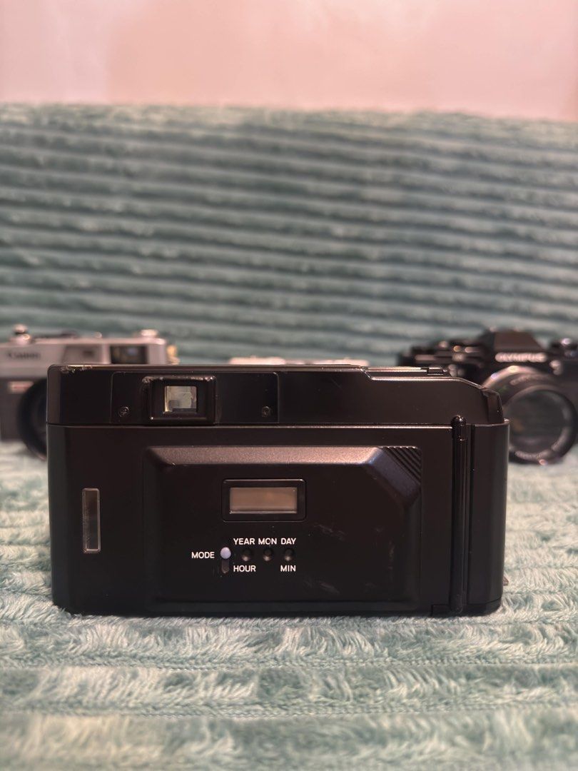 Minolta AF-Tele Quartz Date Camera (Category: Cameras) located in Manila. Submitted by budgetpreloveditems (Listing ID 1433384319, Image 3). Description: - Minolta AF-Tele Quartz Date camera - Dual focal lengths: 38mm and 80mm - Built-in flash - Self-timer function - Date imprinting feature - Sleek black body with red accents -has a tiny insect inside light meter but did not affect camera performance -has loose on off switch but working.