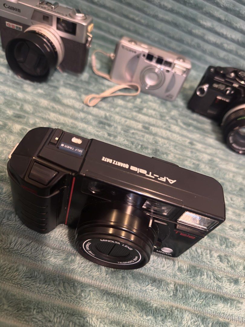 Minolta AF-Tele Quartz Date Camera (Category: Cameras) located in Manila. Submitted by budgetpreloveditems (Listing ID 1433384319, Image 2). Description: - Minolta AF-Tele Quartz Date camera - Dual focal lengths: 38mm and 80mm - Built-in flash - Self-timer function - Date imprinting feature - Sleek black body with red accents -has a tiny insect inside light meter but did not affect camera performance -has loose on off switch but working.