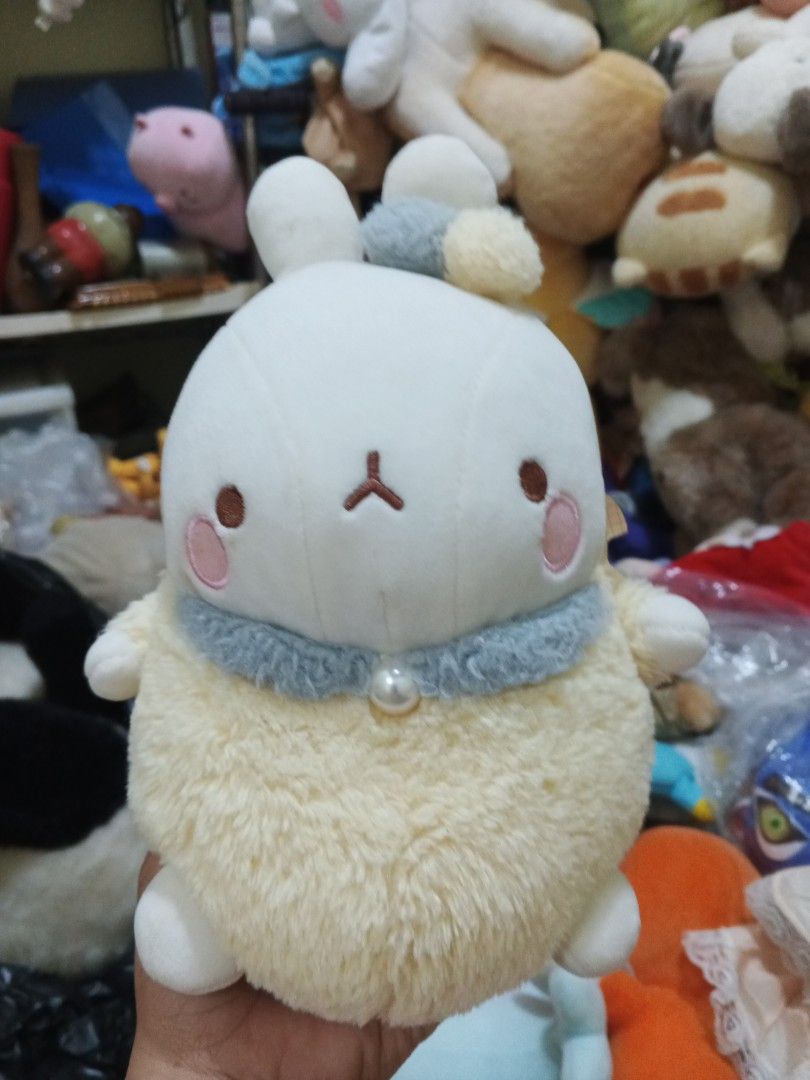 Molang Rabbit Plush Toy (Category: Plushies & Soft Toys) located in Caloocan City. Submitted by surplusandbnewshop (Listing ID 1433262509, Image 1). Description: - Adorable Molang plush toy - Features a round, fluffy cream-colored body - White head with small ears and rosy cheeks - Cute expression - Includes a blue collar with pearl detail - Original Molang tag is visible.