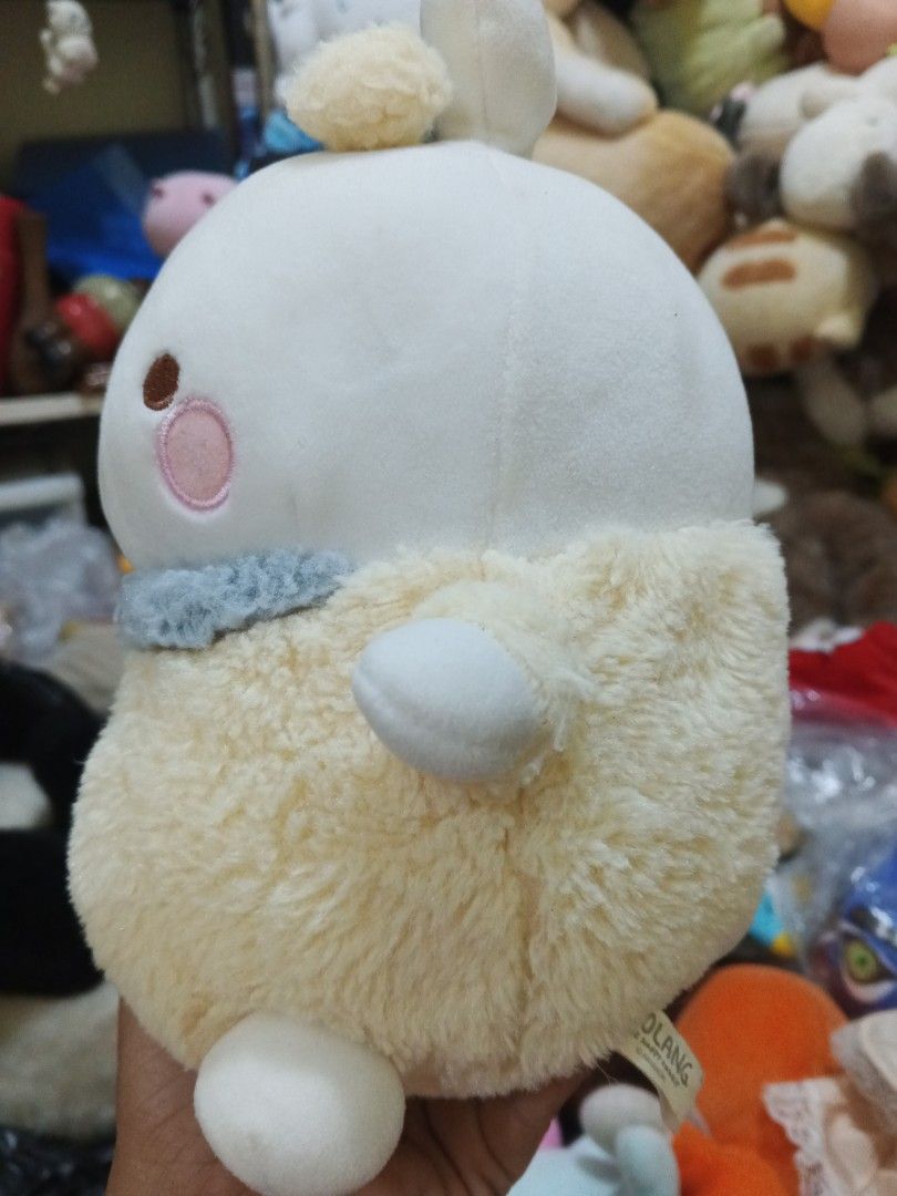 Molang Rabbit Plush Toy (Category: Plushies & Soft Toys) located in Caloocan City. Submitted by surplusandbnewshop (Listing ID 1433262509, Image 2). Description: - Adorable Molang plush toy - Features a round, fluffy cream-colored body - White head with small ears and rosy cheeks - Cute expression - Includes a blue collar with pearl detail - Original Molang tag is visible.