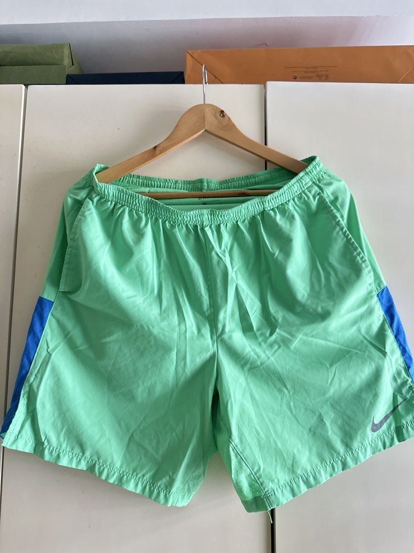 Nike Dri-FIT Shorts - Green (Category: Shorts) located in Taguig. Submitted by jsrbrandeditems (Listing ID 1433223362, Image 1). Description: - Nike Dri-FIT shorts - Vibrant green color - Blue accents on the sides - Elastic waistband - Size: L - Made in Vietnam.