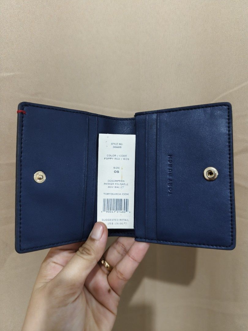 Original Tory Burch Parker Foldable Mini Wallet (Category: Luxury Bags & Wallets) located in Manila. Submitted by findswithalcloset (Listing ID 1433350352, Image 2). Description: -Original Tory Burch Parker Foldable Mini Wallet - Preloved - Rank A condition/excellent - Color: Red exterior, Navy interior - Gold zipper and logo detail - Multiple card slots - Snap closure - Includes style and color tag - Compact and stylish design - Ideal for everyd