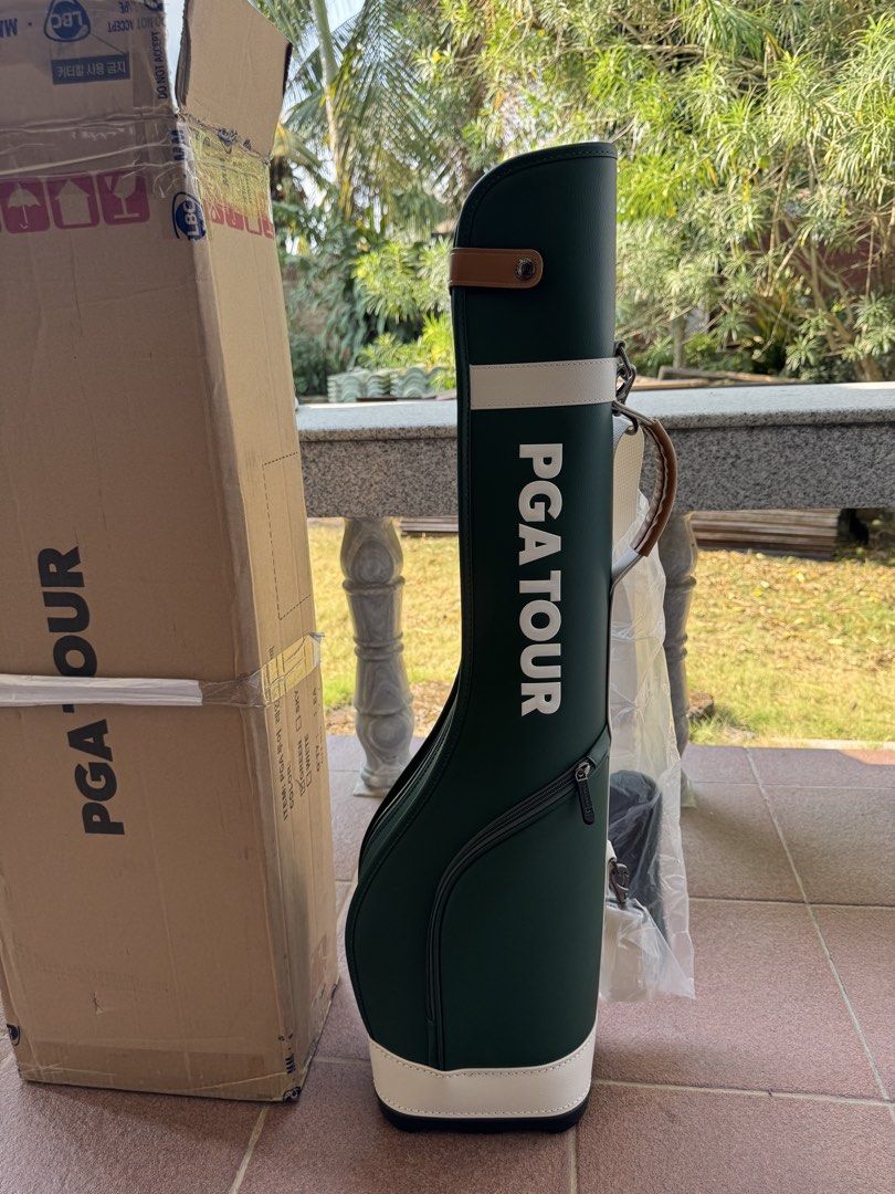 PGA Tour Golf Bag (Category: Golf) located in Bacolod City. Submitted by swagspot (Listing ID 1433281805, Image 1). Description: - PGA Tour golf bag - Color: Green with white accents - Features a shoulder strap - Includes a base with protective feet - Has a zipper pocket - Printed with the words: "Golf is my life, my life is golf" - Comes with original packaging.
