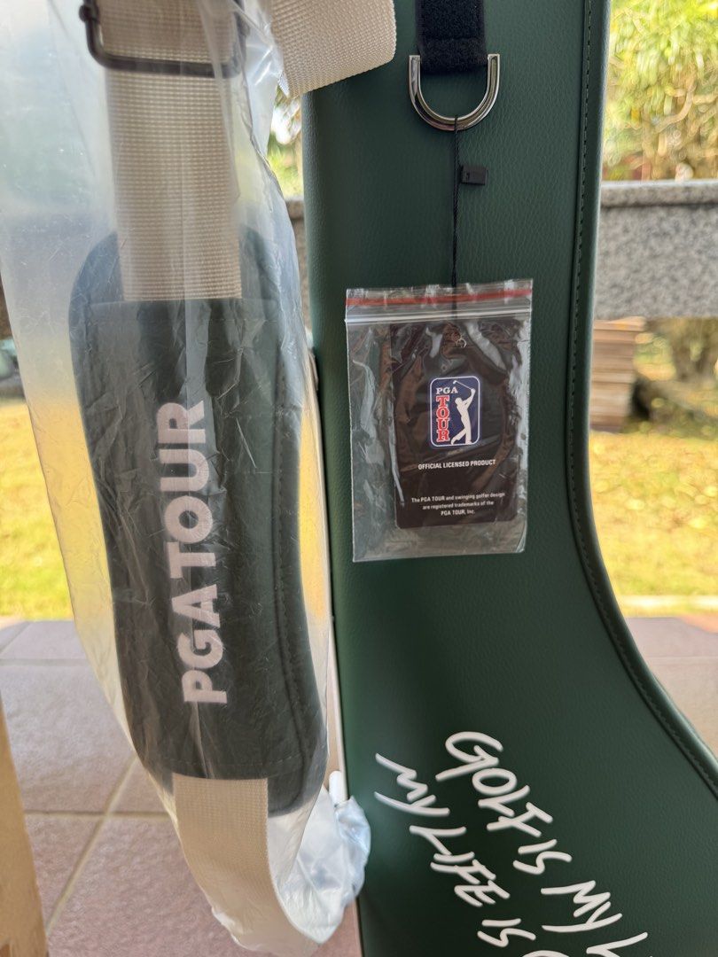 PGA Tour Golf Bag (Category: Golf) located in Bacolod City. Submitted by swagspot (Listing ID 1433281805, Image 2). Description: - PGA Tour golf bag - Color: Green with white accents - Features a shoulder strap - Includes a base with protective feet - Has a zipper pocket - Printed with the words: "Golf is my life, my life is golf" - Comes with original packaging.