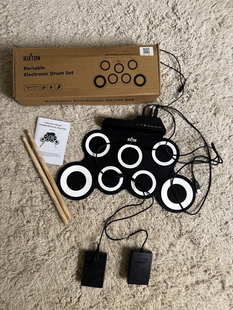 Rixton portable electronic drum with pedals and drumsticks (Category: Musical Instruments) located in Bulacan. Submitted by cocopinn (Listing ID 1433225096, Image 1). Description: Box slightly deformed but drumset no issues. Only used once. Like new. 📍 QC or Malolos, Bulacan.