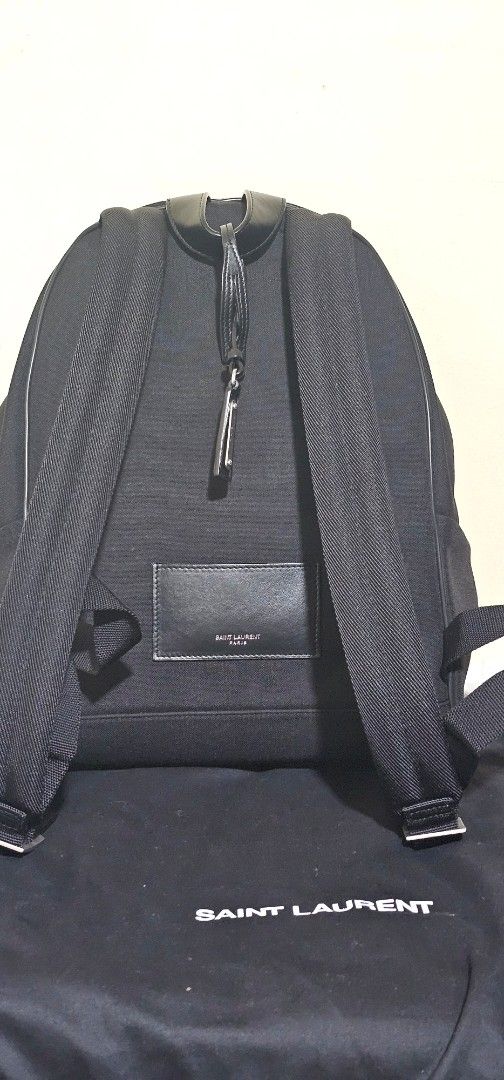 Saint Laurent City Backpack (Category: Luxury Bags & Wallets) located in Cebu City. Submitted by dg_enterprise (Listing ID 1433346514, Image 3). Description: - Authentic Saint Laurent City backpack - Color: Black Canvas - Features a front zip pocket with leather trim and silver-tone zipper - Includes dust bag and authenticity cards - Interior features a Saint Laurent leather patch - Adjustable straps and top handle - Saint Laurent logo visible on