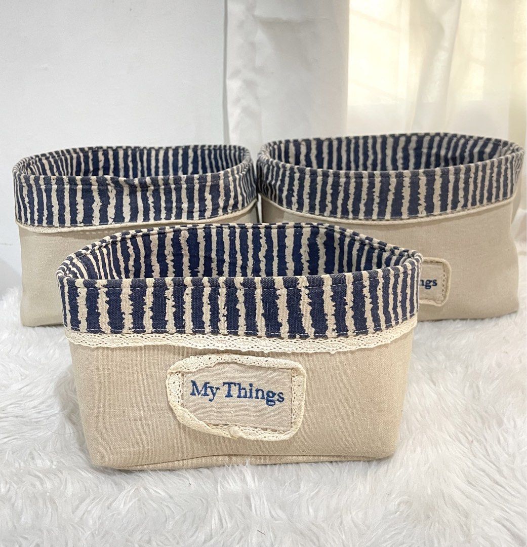 Set of 3 Fabric Storage Baskets (Category: Storage Boxes & Baskets) located in Bayambang. Submitted by foursiblings081228 (Listing ID 1433210615, Image 2). Description: - Set of 3 fabric storage baskets - Beige exterior - Navy blue and white striped interior - Features "My Things" label - Dimensions: Approximately 10 inches x 8 inches x 4 inches - Perfect for organizing small items.