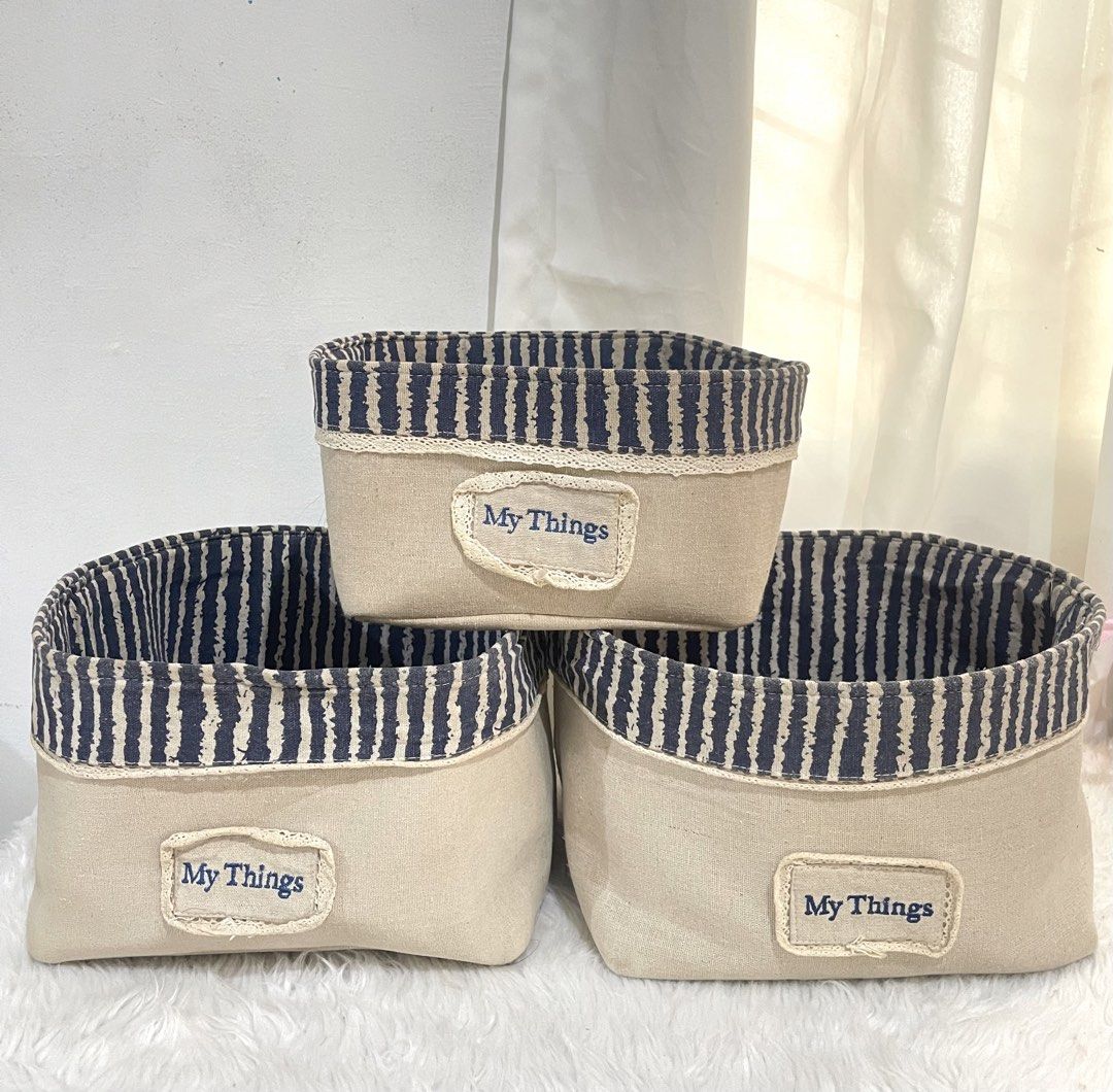 Set of 3 Fabric Storage Baskets (Category: Storage Boxes & Baskets) located in Bayambang. Submitted by foursiblings081228 (Listing ID 1433210615, Image 1). Description: - Set of 3 fabric storage baskets - Beige exterior - Navy blue and white striped interior - Features "My Things" label - Dimensions: Approximately 10 inches x 8 inches x 4 inches - Perfect for organizing small items.