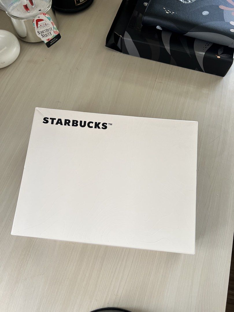 Starbucks Clutch with Coin (Category: Clutches) located in Makati City. Submitted by esila.essentials (Listing ID 1433392029, Image 3). Description: - Starbucks clutch - White topographic design - Navy blue flap - Includes a coin - Comes in a Starbucks box - Gift set.
