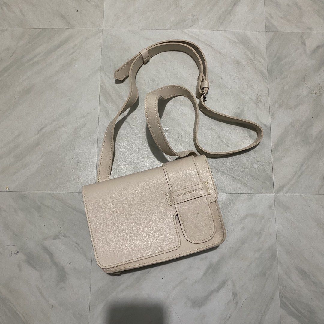 Straightforward Crossbody Bag (Category: Cross-body Bags) located in Mabalacat. Submitted by commando07 (Listing ID 1433360322, Image 2). Description: - Straightforward crossbody bag - Cream color - Rectangular shape - Flap closure - Adjustable shoulder strap - Small front pocket - Leather-like material - Brand logo visible.