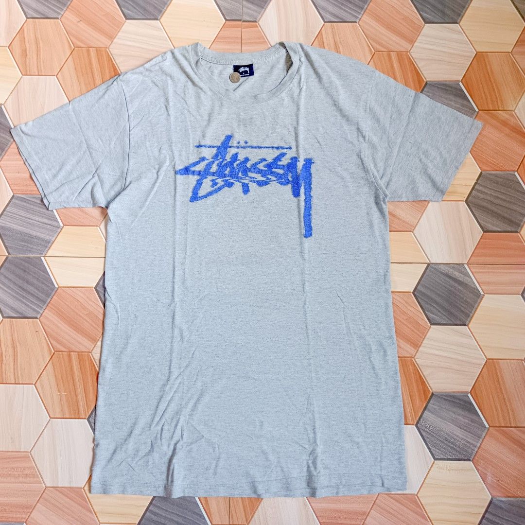 Stussy Gray T-shirt (Category: Tshirts & Polo Shirts ) located in Manila. Submitted by caps08 (Listing ID 1433293786, Image 1). Description: - Stussy T-shirt - Color: Gray with blue logo - Size: Large - Material: 90% Cotton, 10% Polyester - Care Instructions: Machine wash cold, tumble dry low, do not bleach, do not iron, do not dry clean.
