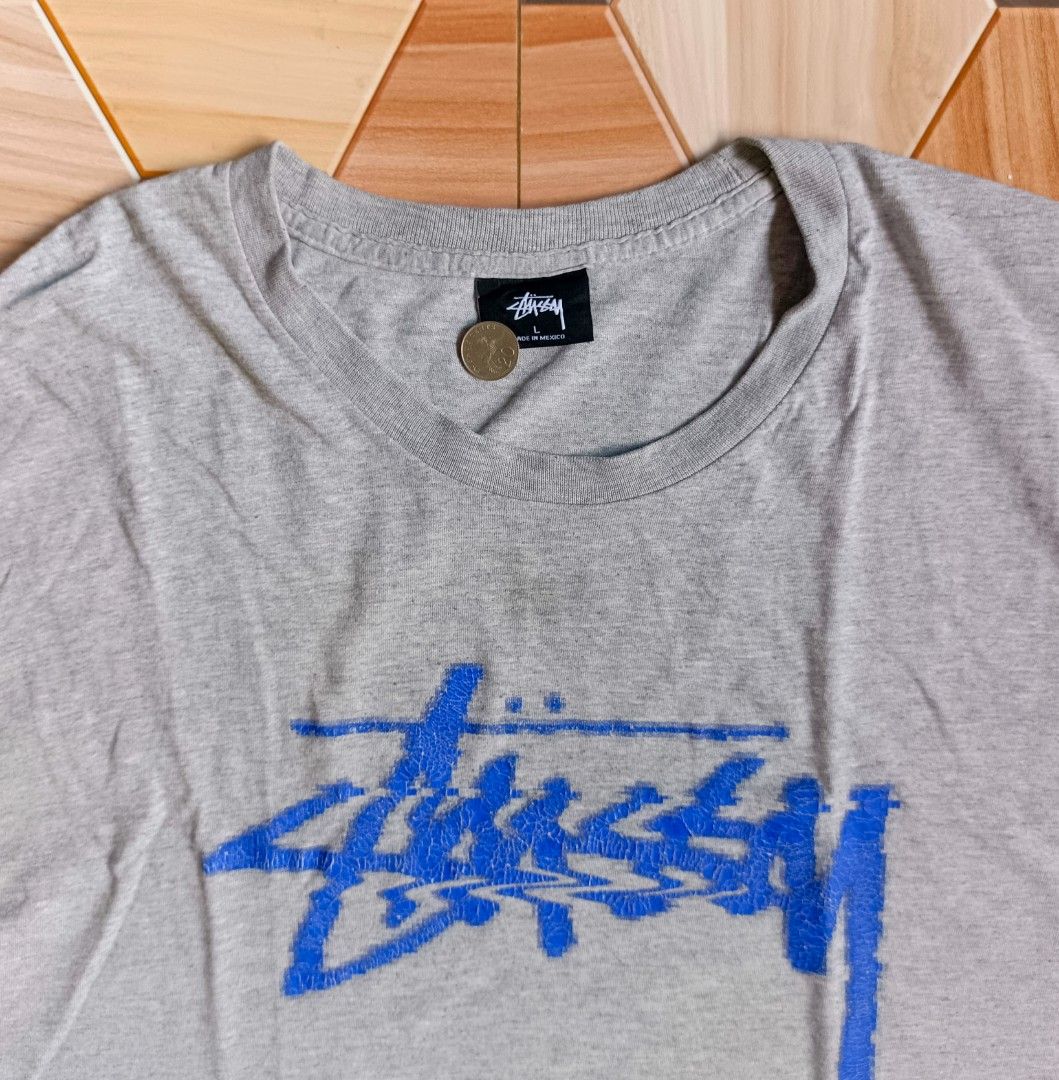 Stussy Gray T-shirt (Category: Tshirts & Polo Shirts ) located in Manila. Submitted by caps08 (Listing ID 1433293786, Image 2). Description: - Stussy T-shirt - Color: Gray with blue logo - Size: Large - Material: 90% Cotton, 10% Polyester - Care Instructions: Machine wash cold, tumble dry low, do not bleach, do not iron, do not dry clean.