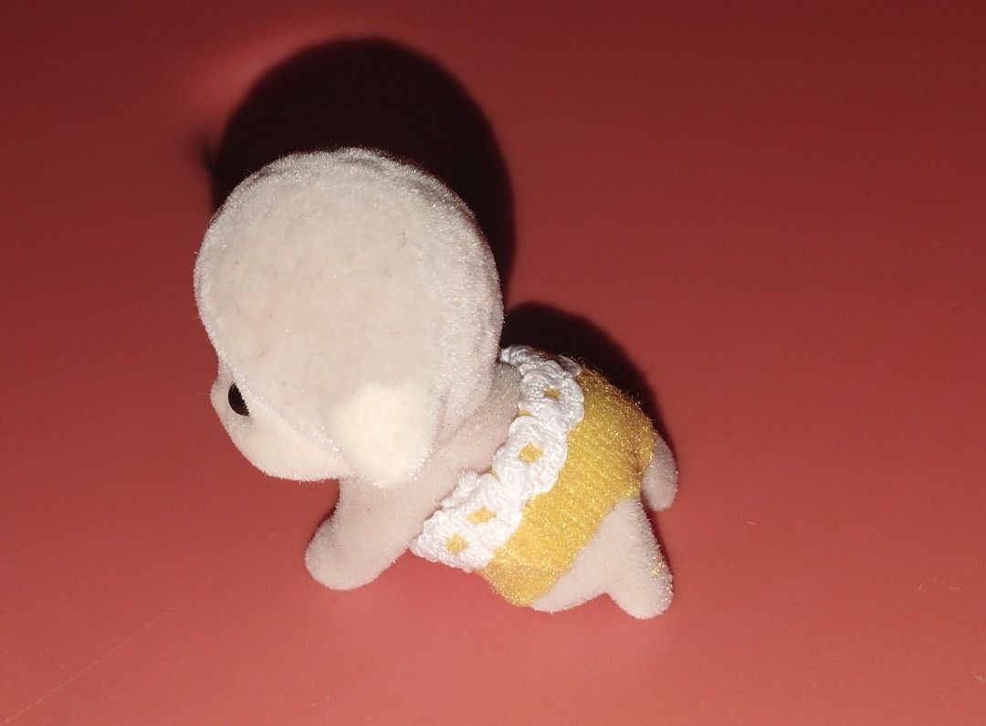Sylvanian Families Baby Lamb (Category: Figurines & Statues) located in Makati City. Submitted by agustinchales24-74032 (Listing ID 1433342169, Image 2). Description: - Sylvanian Families baby lamb figure - Soft, flocked texture - Crawling position - Yellow diaper with white lace trim - Black eyes and small ears.