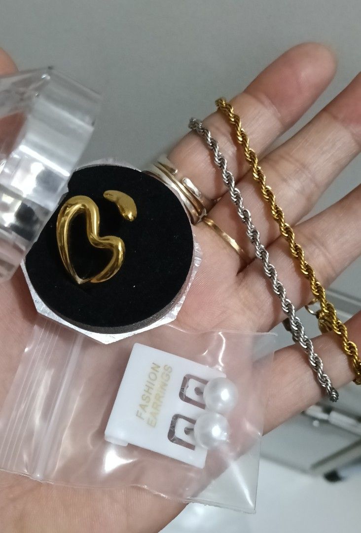Take All Stainless Steel Ring & Bracelets (Category: Luxury Accessories) located in Manila. Submitted by trendyie100 (Listing ID 1432061167, Image 1). Description: Take all na po as is, 1pc Heart Gold Tone Stainless Steel Ring, fit to size 7 or 8 and 2pcs Rope Bracelet, fit up to 7.2inches wrist, hypoallergenic, solid pwede pang everyday use. Pretty in actual. Comes with FREE fashion earrings. •Payment st policy •No return, no exchange, no refund