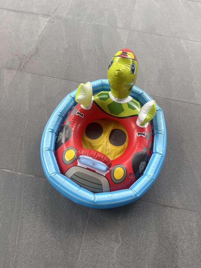 Turtle Car Inflatable Pool Float (Category: Water Sports) located in Singapore. Submitted by .oos. (Listing ID 1433254635, Image 1). Description: - Turtle-themed inflatable pool float. - Features turtle head and arms. - Car-like design. - Perfect for kids..