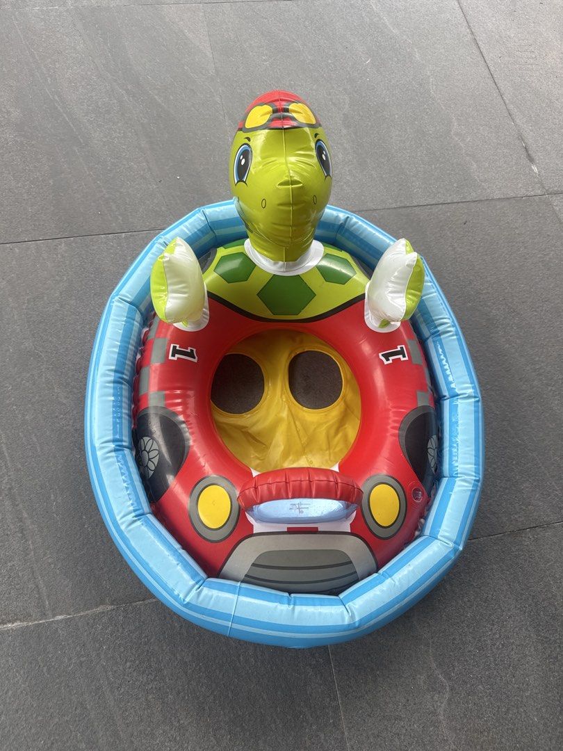 Turtle Car Inflatable Pool Float (Category: Water Sports) located in Singapore. Submitted by .oos. (Listing ID 1433254635, Image 3). Description: - Turtle-themed inflatable pool float. - Features turtle head and arms. - Car-like design. - Perfect for kids..