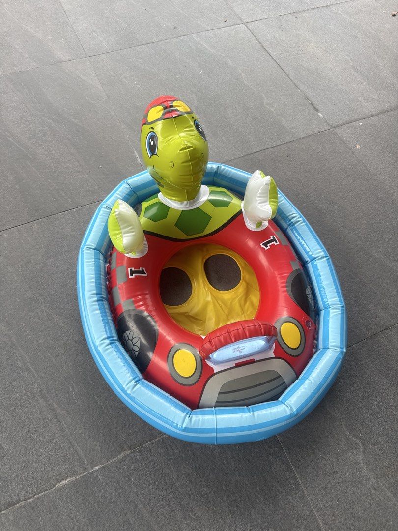 Turtle Car Inflatable Pool Float (Category: Water Sports) located in Singapore. Submitted by .oos. (Listing ID 1433254635, Image 2). Description: - Turtle-themed inflatable pool float. - Features turtle head and arms. - Car-like design. - Perfect for kids..