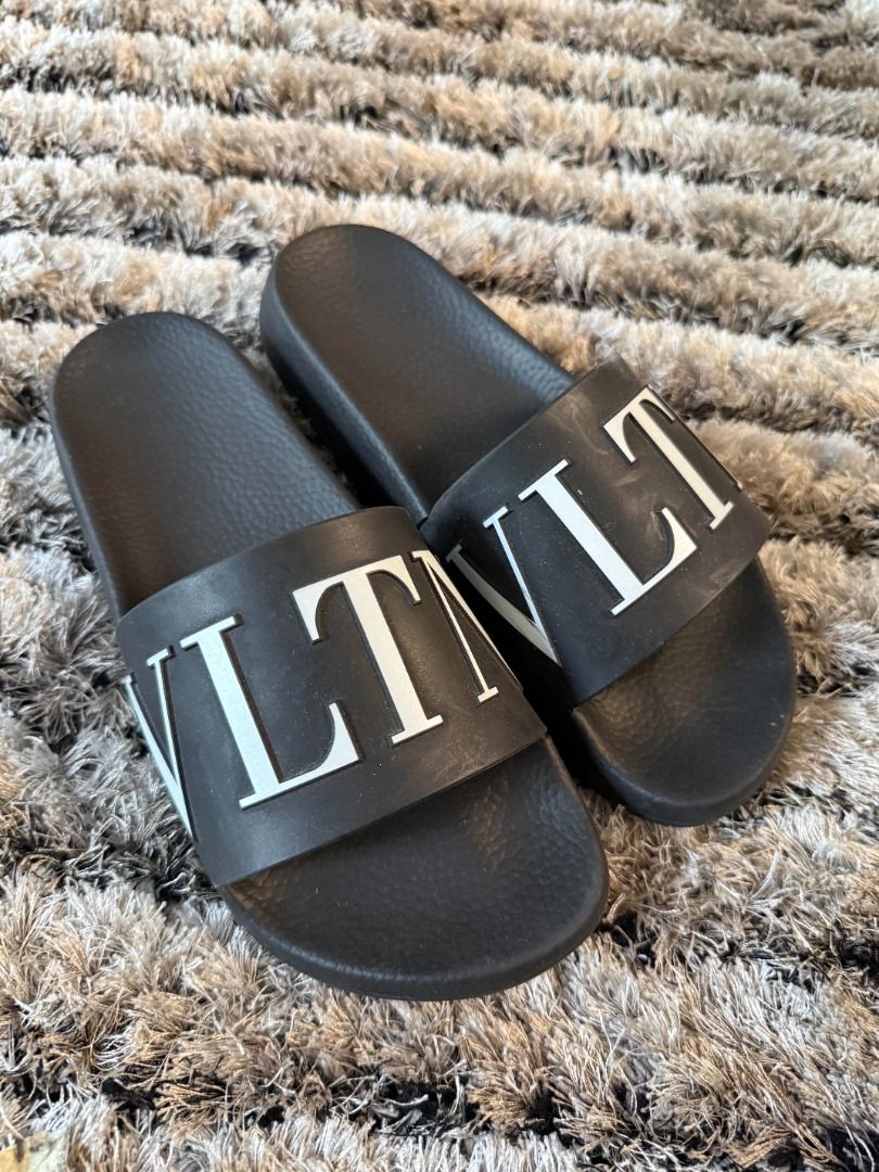 Valentino VLTN Slides (Category: Sneakers & Footwear) located in Muntinlupa City. Submitted by clauisstuff (Listing ID 1433232783, Image 2). Description: 100% AUTHENTIC VLTN Rubber Slides Rarely used Current Retail Price: PHP PHP 27,000 - Size 40, but runs small - VLTN logo in white RFS: Decluttering MOP: BDO/BPI/GotTyme only LOC: Taguig/Muntinlupa.