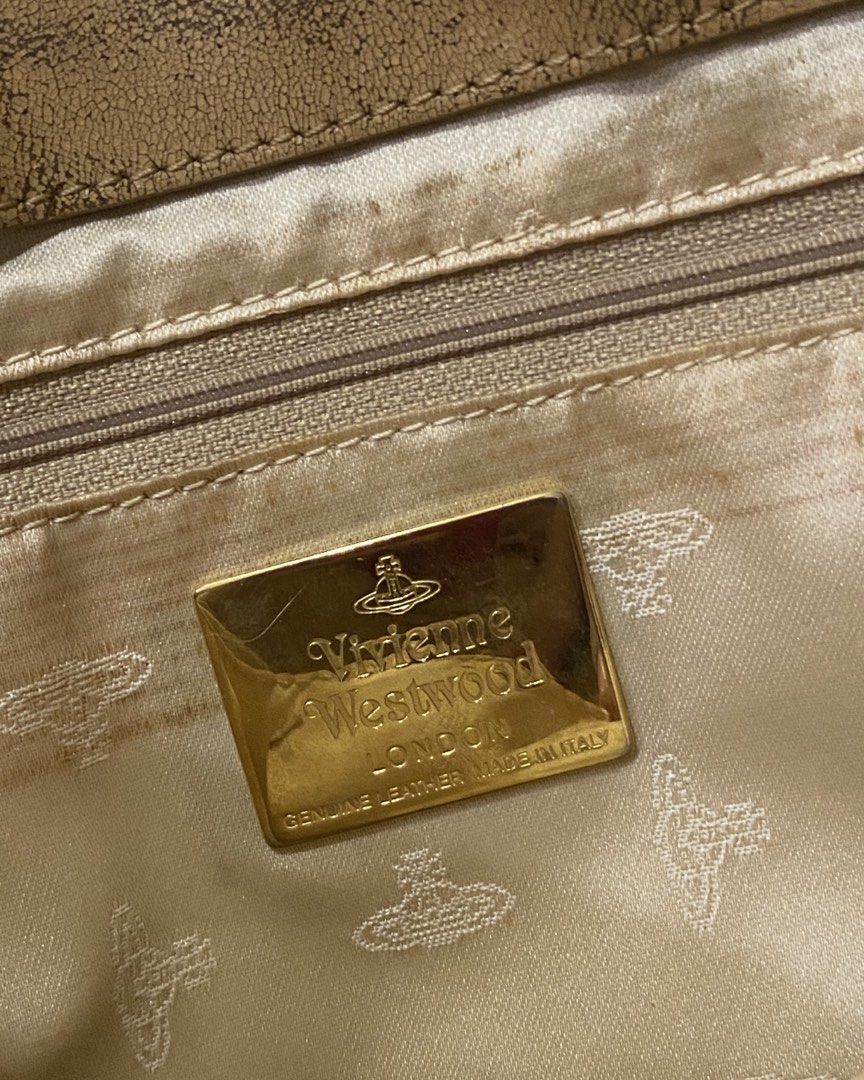 VIVIENNE WESTWOOD TOTE BAG (Category: Luxury Bags & Wallets) located in Quezon City. Submitted by ____sampai (Listing ID 1433252880, Image 3). Description: VIVIENNE WESTWOOD TOTE BAG -Authentic - One Zipper and One Large Pocket Flaw: Accidentally washed on washing machine so leather not in tact but not peeling naman. Covered a ribbon sa handle so not so obvious.