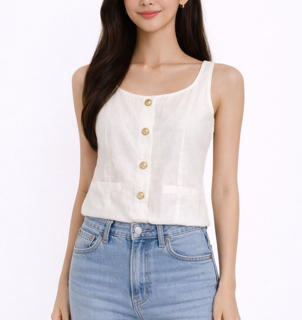White Blouse (Category: Sleeveless) located in Manila. Submitted by declutteREN (Listing ID 1433265278, Image 1). Description: - White tank top - Square neckline - Gold button detail - Two small pockets - Fitted silhouette - Sleeveless design - Lightweight fabric - Great for warm weather - Pairs well with jeans or skirts.