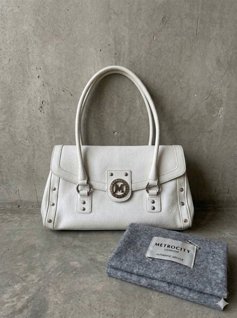 White Leather Handbag (Category: Luxury Bags & Wallets) located in Dasmarinas. Submitted by closetnqueens (Listing ID 1433318602, Image 1). Description: - White leather handbag - Top handles - Silver-tone hardware - Decorative stud - Textured leather exterior - Pink stitching details - Metal feet at base.