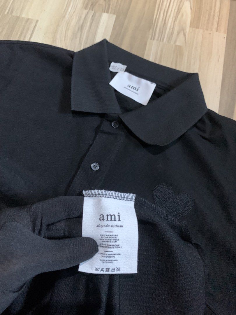 AMI Paris Black Polo Shirt (Category: Tshirts & Polo Shirts ) located in Calamba. Submitted by thriftsmack69 (Listing ID 1433475244, Image 3). Description: DETAILS ‼️ Excellent condition No flaws Color rate 10/10 Dimes 22 x 27 CLAIM 1599 automatic yours ‼️ - AMI Paris black polo shirt - Features the AMI de Coeur logo - Classic collar - Short sleeves - 100% cotton - AMI logo on collar.