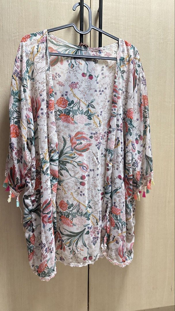 Beach Cover Up / Kimono with Tassels (Category: Coats, Jackets and Outerwear) located in Valenzuela. Submitted by jam0816 (Listing ID 1433577270, Image 2). Description: - Floral print kimono - Lightweight, flowy fabric - Colorful tassels on sleeves - Ideal for layering over dresses or tops - Perfect for casual wear - can be used as cover up.