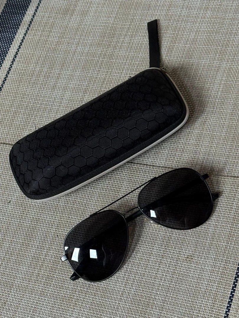 Black Aviator Sunglasses with Case (Category: Sunglasses & Eyewear) located in Makati City. Submitted by ca.declutter (Listing ID 1433559779, Image 1). Description: - Black aviator sunglasses - Sleek black frame - Dark lenses - Includes matching black case - Textured case design - Great for everyday wear - Stylish eye protection.