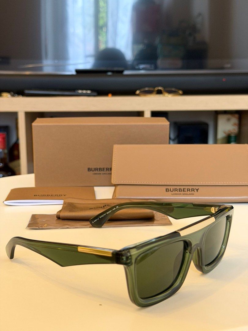 Burberry BE4451U Eye Wear (Category: Sunglasses & Eyewear) located in Quezon City. Submitted by _cmluxephilippines (Listing ID 1433531174, Image 3). Description: Burberry BE4451U model in a transparent green colorway. These rectangular-frame sunglasses are part of Burberry's modern eyewear collection and are known for several distinctive design features: Pretavoir Pretavoir +1 Design Details: They feature a polished gold metal brow bar that runs 