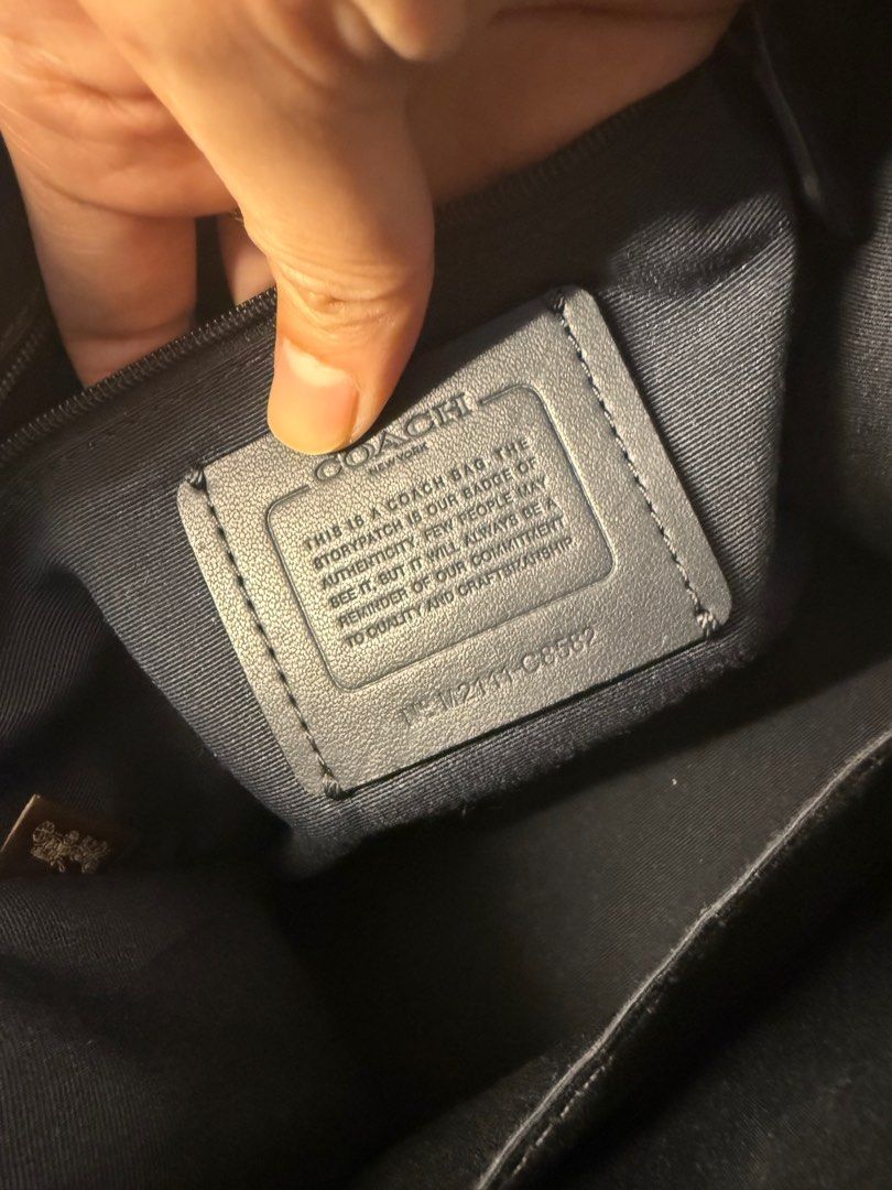 Coach Dempsey 22 (Category: Luxury Bags & Wallets) located in San Pablo. Submitted by liezlmr (Listing ID 1433517956, Image 3). Description: - Coach City Tote Bag - Signature pattern - Navy and white color scheme (denim) - Detachable shoulder strap - Top handles - Interior zippered pocket - Coach leather tag - Circular Coach logo on front.
