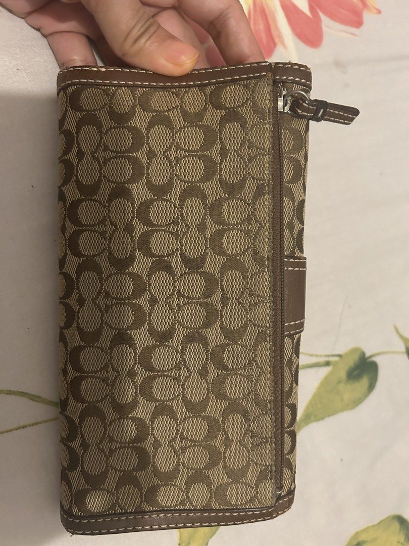 Coach Signature Buckle Wallet w/ Checkbook (Category: Luxury Bags & Wallets) located in Caloocan City. Submitted by leanhaze2627 (Listing ID 1433408577, Image 2). Description: - Authentic Coach wallet - Signature brown pattern - Buckle closure - Zip pocket - Multiple card slots - Clear ID window - Made with brown leather and signature coated canvas - Classic design - Practical layout - no damage at all - old style .