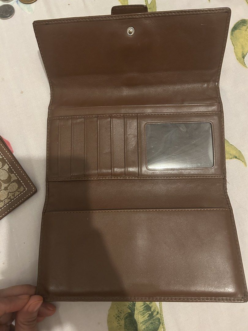 Coach Signature Buckle Wallet w/ Checkbook (Category: Luxury Bags & Wallets) located in Caloocan City. Submitted by leanhaze2627 (Listing ID 1433408577, Image 3). Description: - Authentic Coach wallet - Signature brown pattern - Buckle closure - Zip pocket - Multiple card slots - Clear ID window - Made with brown leather and signature coated canvas - Classic design - Practical layout - no damage at all - old style .