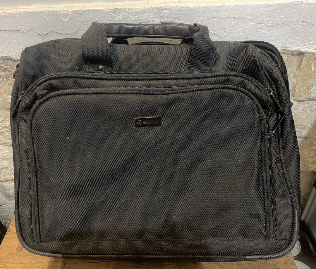 Emir Laptop Bag - Black (Category: Laptop Bags & Sleeves) located in San Fernando. Submitted by japansurpluselyu (Listing ID 1433567492, Image 1). Description: 17x13 - Black laptop bag - Multiple compartments and zippers - Top handle and shoulder strap - Front pocket and internal pockets - Durable, textured fabric - Features a small Emir logo.