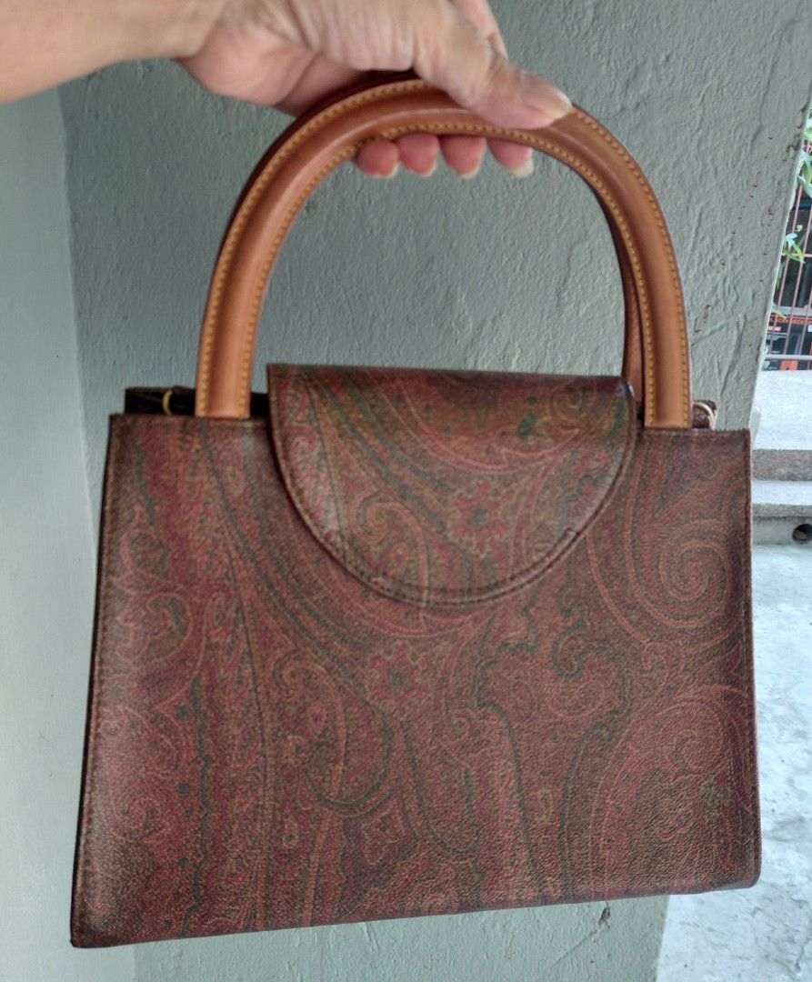 Etro Paisley Print Handbag with Shoulder Strap (Category: Luxury Bags & Wallets) located in Makati City. Submitted by fiestypam (Listing ID 1433525020, Image 2). Description: - Authentic Etro handbag - Signature paisley print - Top handle and detachable shoulder strap - Flap closure with gold-tone accent - Includes dust bag - Interior zip pocket -1 Handle shows some wear NO COD/COP.