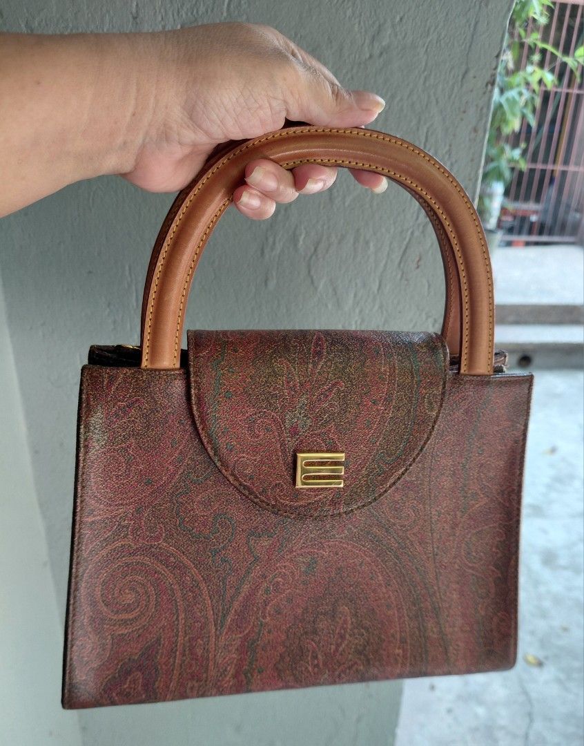 Etro Paisley Print Handbag with Shoulder Strap (Category: Luxury Bags & Wallets) located in Makati City. Submitted by fiestypam (Listing ID 1433525020, Image 1). Description: - Authentic Etro handbag - Signature paisley print - Top handle and detachable shoulder strap - Flap closure with gold-tone accent - Includes dust bag - Interior zip pocket -1 Handle shows some wear NO COD/COP.