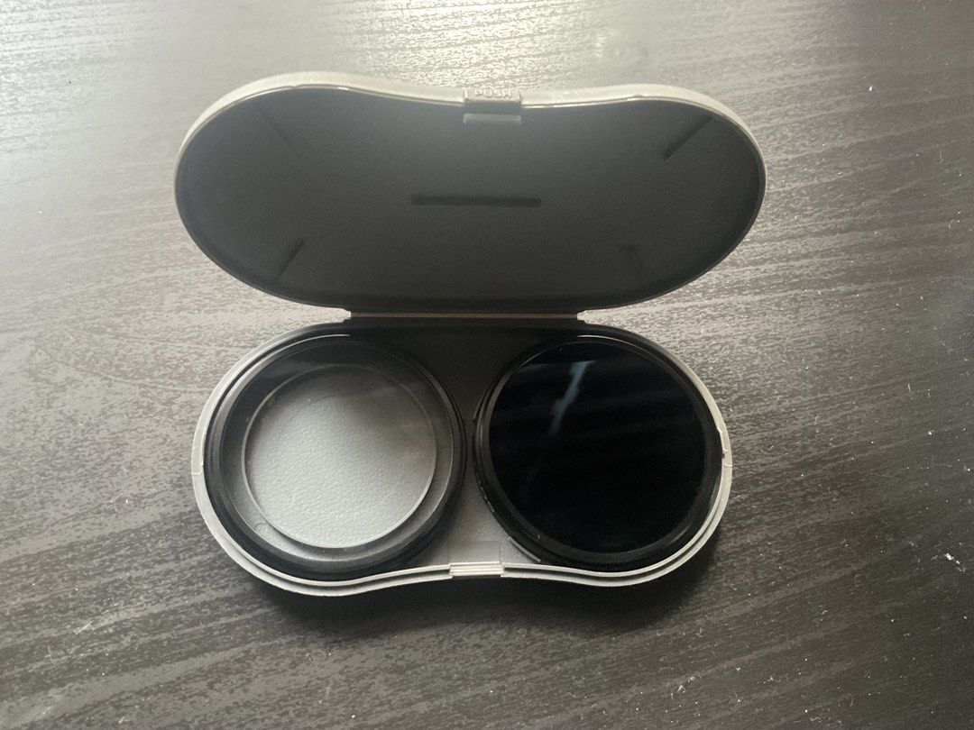 filter kit sony for lens (Category: Cameras) located in Manila. Submitted by geloreyes262956 (Listing ID 1433437116, Image 2). Description: The image shows a camera filteri kit, likely a vintage Sony PL filter kit, which includes a polarizer filter and a protector filter in a plastic carrying case. Content: Contains two circular filters (one clear, one dark/polarizing). Purpose: Filters are used to reduce glare, control reflections, or protect th