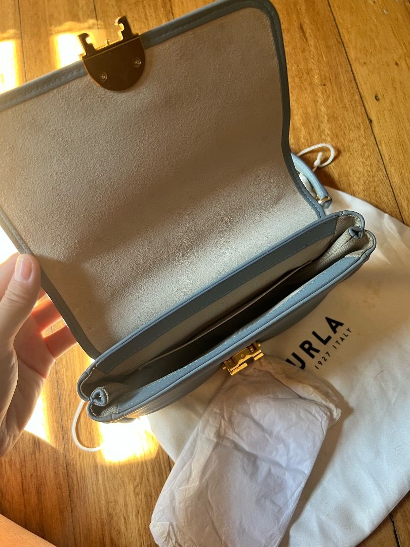 Furla Mini Crossbody Bag (Category: Luxury Bags & Wallets) located in Caloocan City. Submitted by peppery14 (Listing ID 1433467996, Image 3). Description: - Pre-loved - Authentic Furla Metropolis Mini crossbody bag - Light blue color - Gold-tone chain strap - Signature Furla lock closure - Includes dust bag and tag - Multiple interior compartments - Made in Italy.