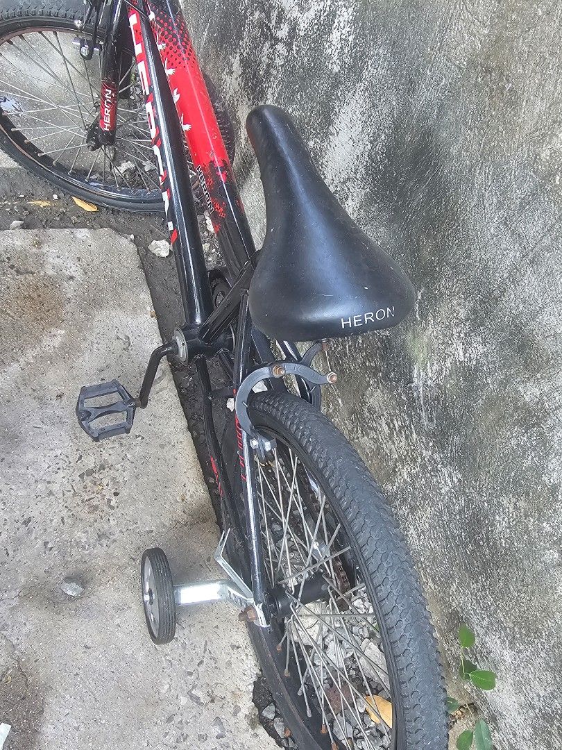 Heron BMX Bike with Training Wheels (Category: Bicycles) located in Paranaque City. Submitted by charlottearrio_23 (Listing ID 1433581271, Image 3). Description: - Heron BMX bike - Color: Black and red - Features black seat, handlebars, and pedals - Includes training wheels - Sturdy frame - Good tire tread - Suitable for beginner riders - Ready to use with signs of usage as you can see in the pic may Rust na ang bike..