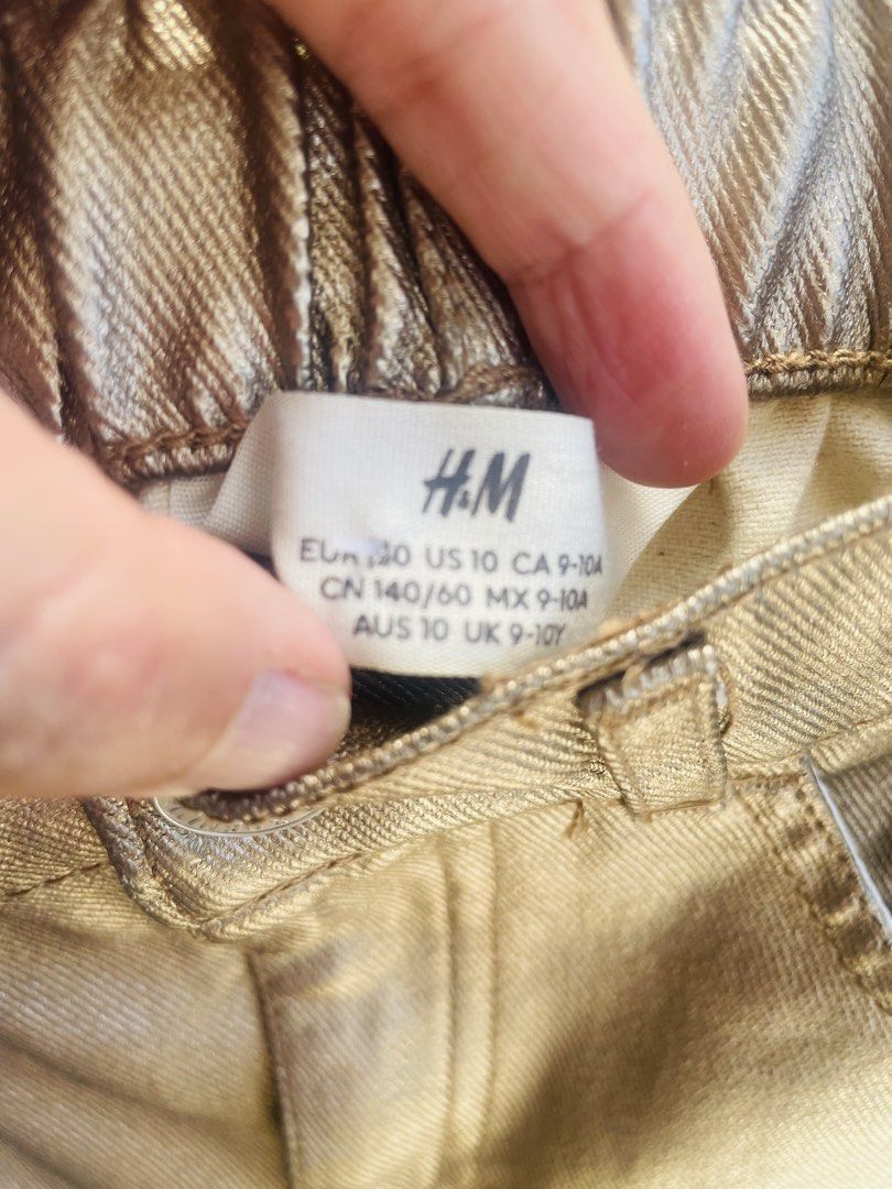H&M Metallic Skirt - Size 10 (Category: Babies & Kids Fashion) located in Taguig. Submitted by bestthriftxx (Listing ID 1433501155, Image 2). Description: - H&M metallic gold skirt - Size 10 (fits ages 9-10) - Gold finish - Elastic waistband - Classic five-pocket design - Button closure - Belt loops - Adds a touch of shine.
