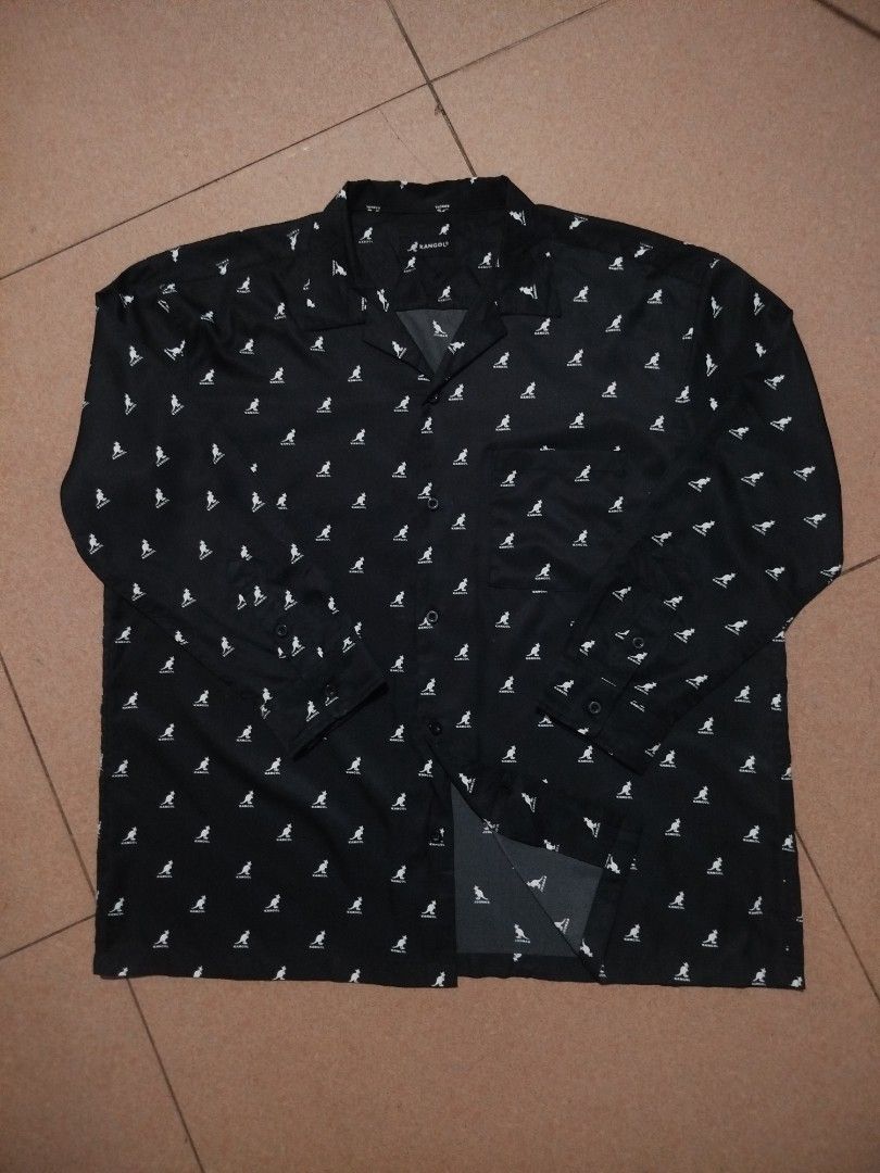 Kangol Long Sleeve Shirt (Category: Formal Shirts) located in Las Pinas. Submitted by jairoonde (Listing ID 1433468892, Image 2). Description: - Black long sleeve shirt - Features white Kangol logo pattern - Collared neckline - Button-down closure - Chest pocket - Buttoned cuffs.